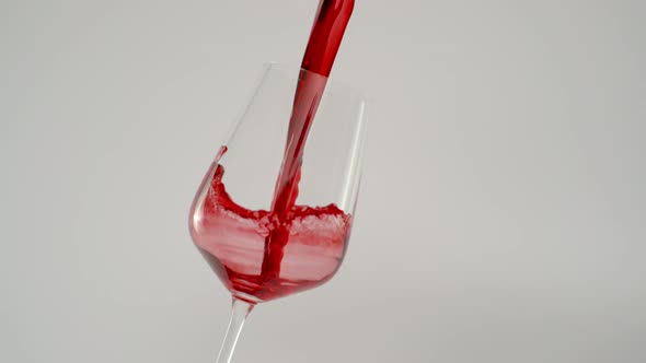 Slow Motion of Pouring Wine in Tilted Glass at 1000 Fps White Background alt