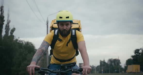 Bicycle Messenger Cycling on a Road alt