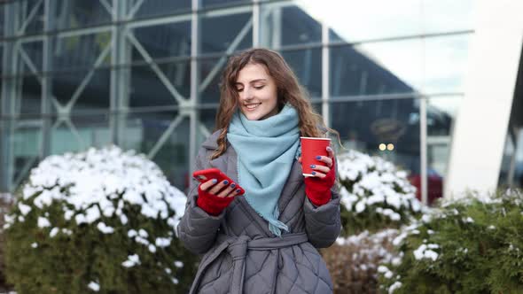 Modern Stylish Curly Woman With Cup Coffee Uses Her Smartphone Being Online Social Networks