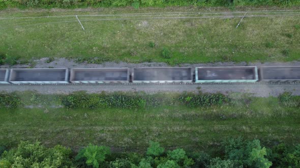 Aerial view of a freight train carrying empty alt