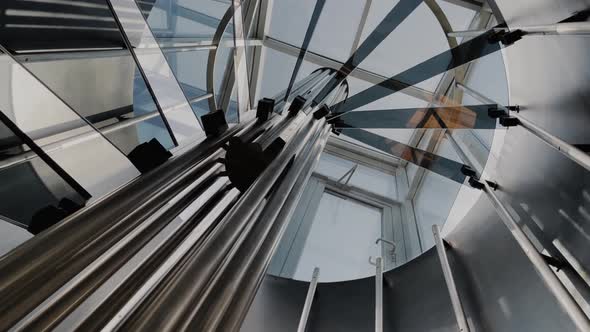 Designer spiral staircase in high-tech style leading to the roof of the house alt