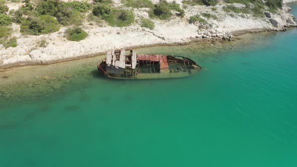 Super wide shot of a ship wreck stranded on a beautiful hidden beach in Croatia. Parallax shot of th alt