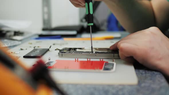 A Man Is Taking a Spare Mobile Phone That Still Works in Use and Has Been Recycle. Preparing To alt