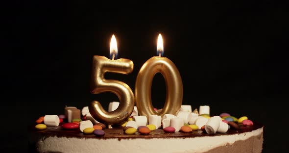 Fiftieth Anniversary Number Fifty Candle on Cake