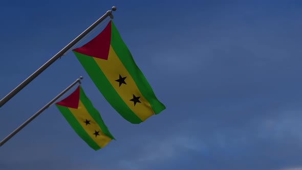 Sao Tome And Principe Flags In The Blue Sky - 4K