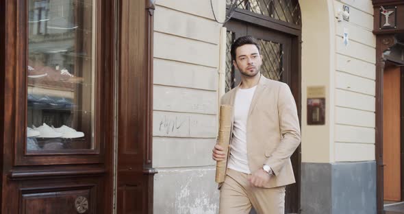 Man Walks Around The City With A Newspaper In His Hands alt