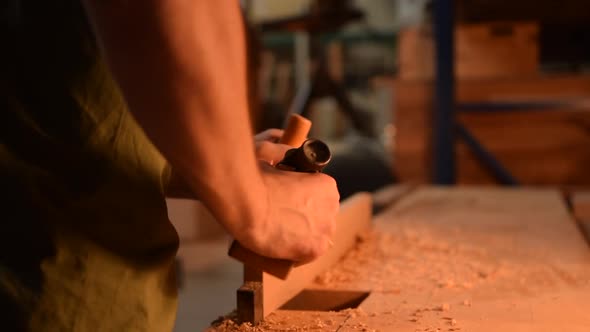 The Carpenter Planes the Wood alt