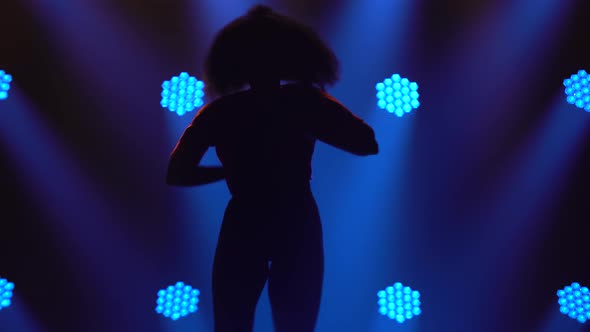 Modern Choreography Jazz Funk Performed By a Young Girl. Silhouette in a Dark Studio alt