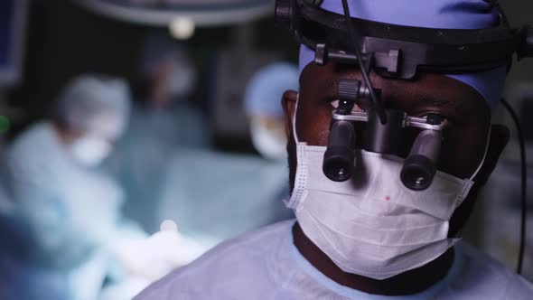 Male surgeon standing against the background of operation