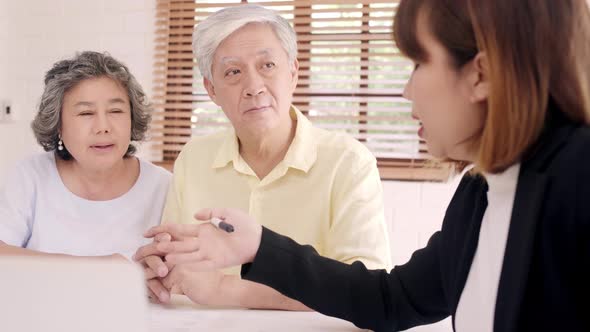 Asia smart female agent offers health insurance for elderly couples by document