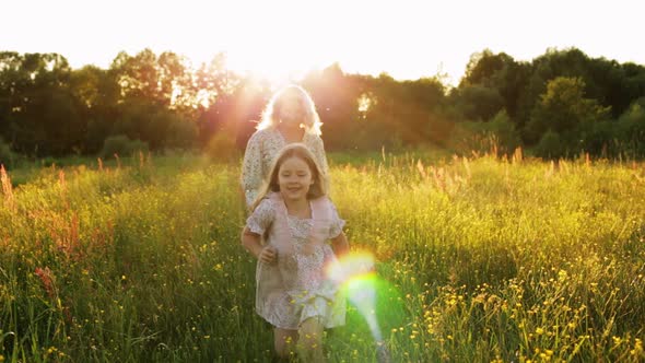 Happy Woman with Daughter in Field alt