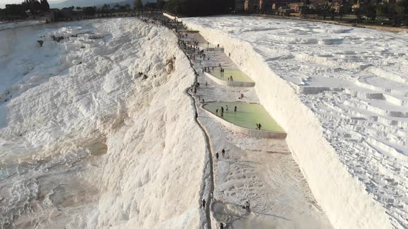 Visitors and Tourist People Walks Pamukkale's Calcium Carbonate Travertines alt