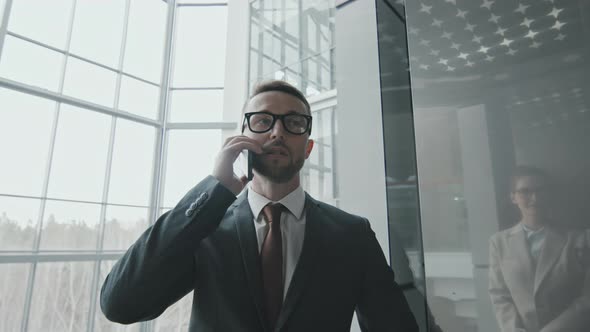 Businessman Talking on Phone in Elevator alt