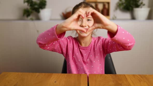 Little Girl Making Hearts From Hands Love