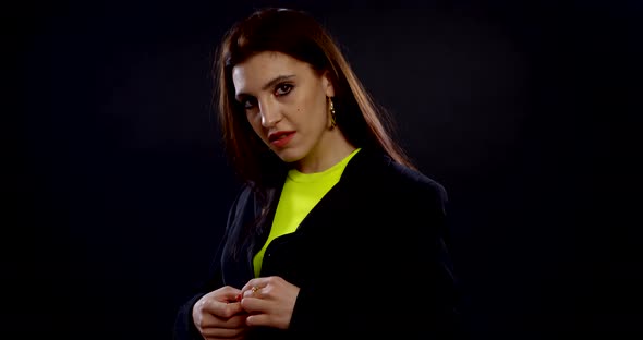 Young Pretty Woman Is Wearing Jacket, Fastening It and Smiling at Camera, Portrait alt