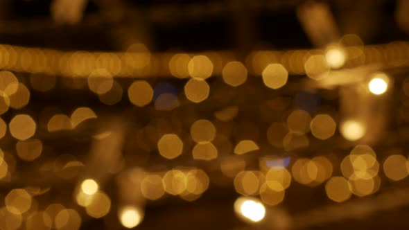 Defocused Holiday Lights Glowing in Darkness in Night City Streets