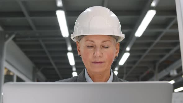 Businesswoman Running Industrial Factory and Visiting Production Workshop Using Portable Computer alt