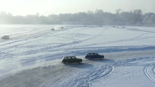 Drone Shot of Two Racing Cars Sliding on an Ice Track