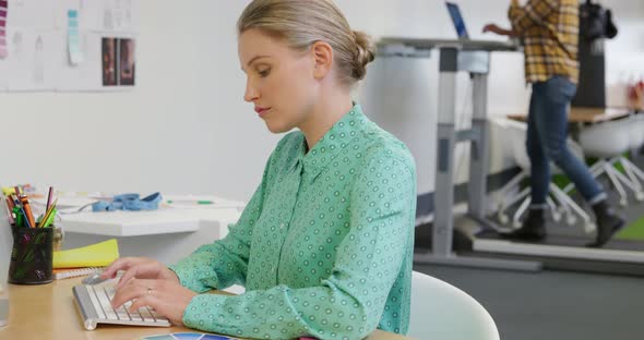 Young man and woman working in a creative office alt