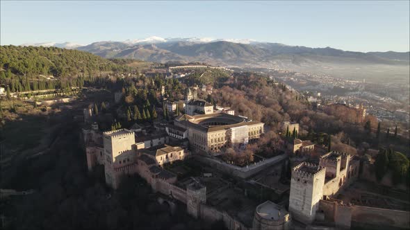 Flying towards Iconic Palace, The Alhambra complex, Mountain range Background. Granada