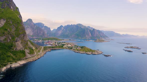 Pan Right of Reine Fishing Village with Mountains and Fjords on Lofoten Islands alt