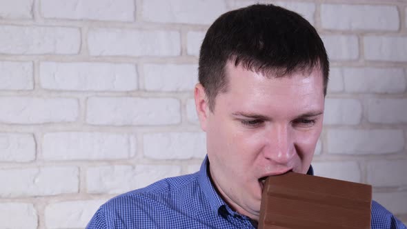 Man Eating Milk Chocolate Closeup