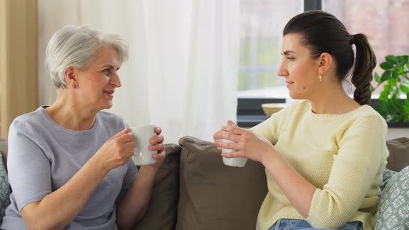 Senior Mother and Adult Daughter Drinking Coffee alt