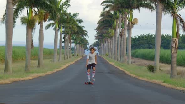 Young Cool Man Teenager Hipster in California Rides His Skateboard on Boardwalk Beach alt
