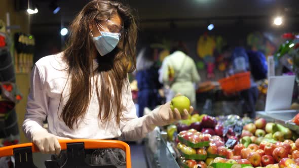 Woman with the Surgical Mask and the Gloves Is Shopping in the Supermarket alt