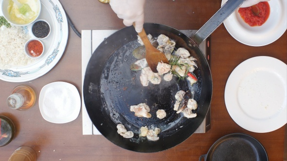 Mixing Seafood in A Pan During Cooking