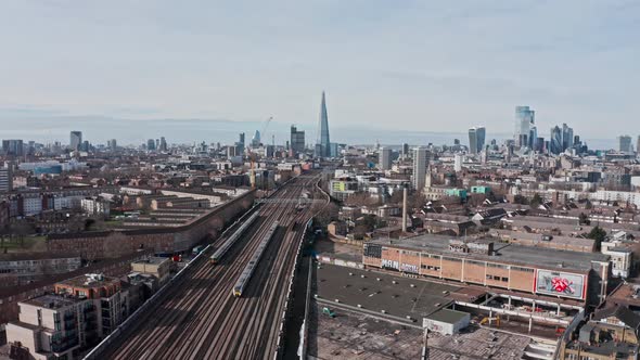 aerial drone shot of trains entering central London bridge station shard alt
