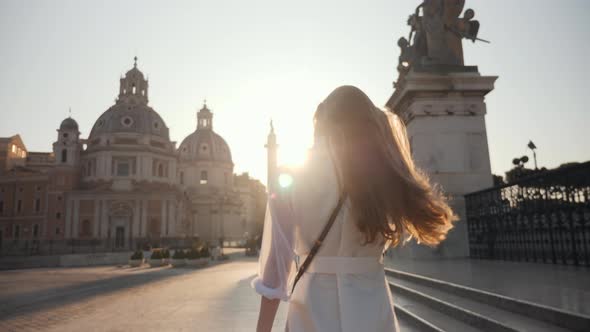 Portrait of Young Tourist Woman Exploring European Town at Sunrise