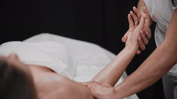 Young Woman Receiving a Massage  Soft Massaging Her Hand alt