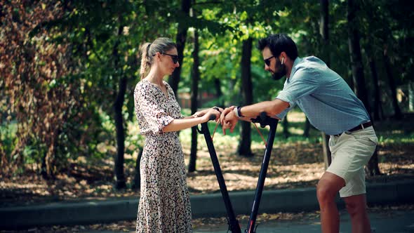 Driving Ecology Transportation. Man Ride Electric Scooter Mobility. Electric Scooter In City. alt
