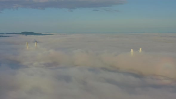 Tops of the Pylons of the Golden Bridge in the Dawn Fog in Vladivostok alt