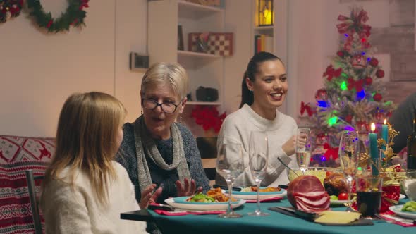 Grandmother Giving Her Little Grand Daughter a Gift alt