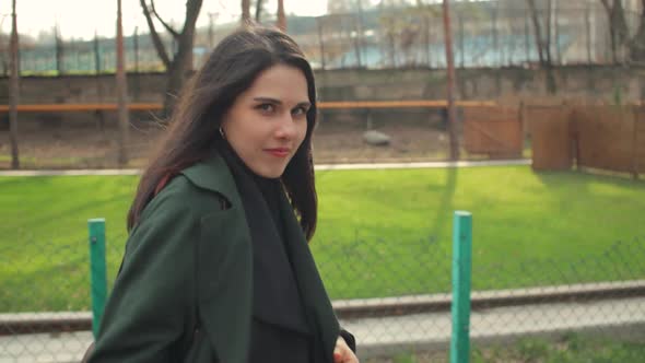 Playful Young Woman Walking in the Park in Sunny Weather in Spring