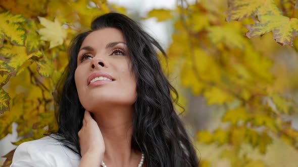 Stunning Brunette Woman in Park in Autumn Day Closeup Portrait in Background of Yellowed Maple alt