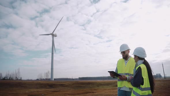 Ecological Engineers Use Digital Tablet and Talk at the Windmill Field