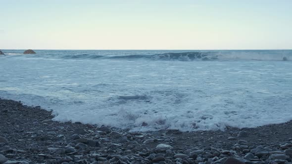 Continuous waves hitting the rocky beaches of Serra de Dentro captured in 4K footage. alt