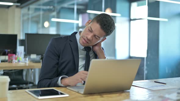 Tired African Businessman Having Neck Pain in Office alt