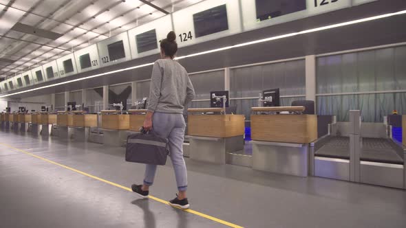 The Girl Goes To the Terminal for Registration with a Bag alt