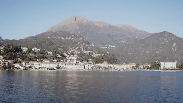 view of Menaggio in Northern Italy with a view of Lake Como and swiss alps in the background alt
