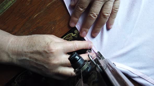 Repairing a sheet with antique sewing machine