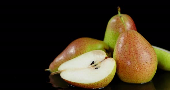 Whole and Half Fresh Pear Lying on the Water.  alt