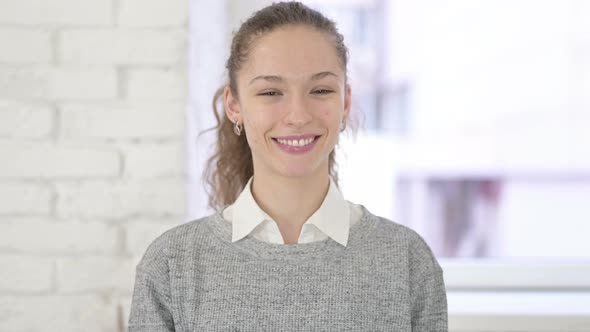 Portrait of Beautiful Young Latin Woman Saying Yes By Head Shake alt