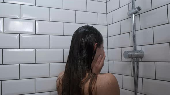 Sad Depressed Girl Crying in Shower Under Running Water Back View Close Up alt