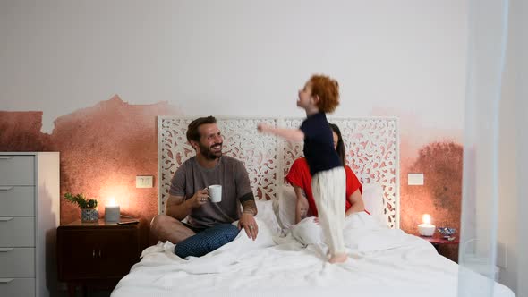 Family playing on bed in the morning alt