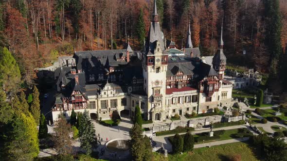 Aerial drone view of The Peles Castle in Romania. Castle with gardens in Carpathians, forest around  alt