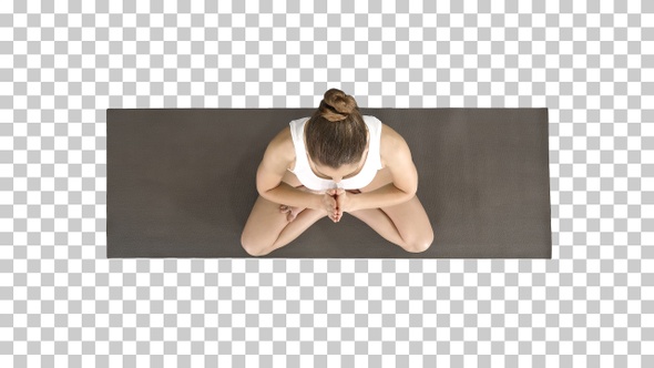 Young yogi woman practicing yoga making namaste gesture in alt